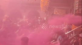 Devotees covered in vibrant powder as India celebrates Holi, the festival of colours
