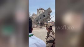 Three-storied building under construction tilted in western India; Citizens run