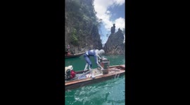 Spider Man sells ice cream to tourists on boat in Thailand
