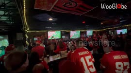 Excited KC Chiefs fans blow the roof off of a pub after their team wins Super Bowl 58