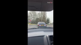 Women cheer from inside their car when an amateur driver manages to drive on