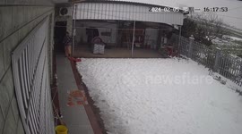 Child narrowly escapes being buried under mass of melting snow falling from roof