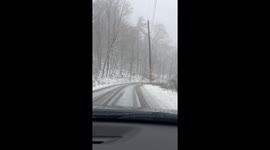 Car Slides Into Snowy Ditch