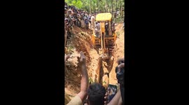 Elephant calf stuck in well rescued with excavator in India (vertical)