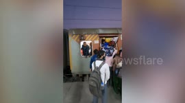Passengers squeeze into TOILET on overcrowded train in India