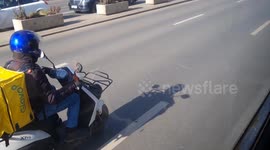 Food delivery courier on the road in Bucharest, Romania
