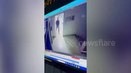 Handcuffed 'people smuggler' casually walks out of police station