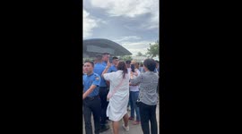 Crying cadet whose family missed graduation comforted by other parents