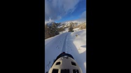 Skier weaves in and out of snow-covered chalets in Switzerland
