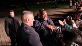 Dizzee Rascal attempts to give away his Burberry coat to a fan in London