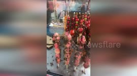 Stall owner chased away by swarm of bees attracted by fruit