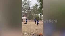 Schoolchildren enjoy playing in whirling dust devil