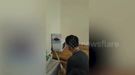 Snake hides behind microwave's kitche before being caught