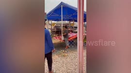 Gusts blow away market stalls as storm approaches in Thailand