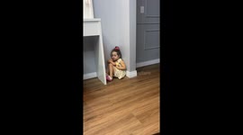 Delightful scene unfolds as younger sibling awakens, laughs, and enjoys a cookie