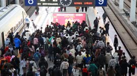People exit a railway station in Nanjing, China
