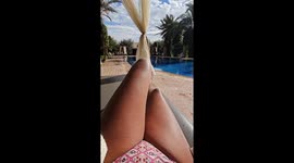 Girl sitting at the swimming pool