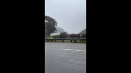 Semi Truck slides off freeway in rain storm