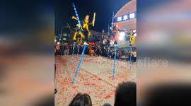 Stilt walker falls during performance as spectators help him stand up