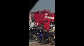 Pet dog on motorcycle enjoys snacks at traffic light