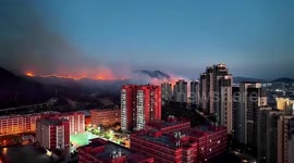 Smoke engulfs mountain as firefighters struggle to extinguish raging wildfire