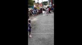 Youth enthusiastically play Vitilla in Herrera, Dominican Republic
