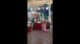A man wearing frog costume makes and sells cotton candy at a local market in Chiang Mai, Thailand.