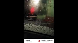 Worm-like freezing rain cascades onto car in China