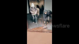 Residents use brooms and leaf blower to clean themselves and buildings after sandstorm hits China