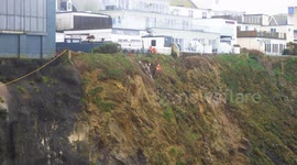 Ibex Aerial rope workers on cliff stabilisation works at above Great Western Beach, Newquay, Cornwall, UK