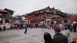 Visitors Watch a Performance of Intangible Cultural Heritage in Enshi, China