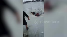 Security guard wades through ice to rescue children who fell into frozen pond