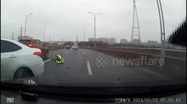 Car skidding on icy road hits traffic officer in eastern China