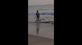 A Russian tourist angling in the shallow waters at Cavelossim beach in the Indian state of Goa