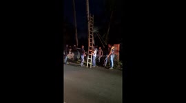 Electricity department officials in Indian state of Goa trying to fix the snapped power line wires during a night time accident