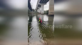 Police and Firefighters Rescue Vehicle Stranded in River in Roma, USA