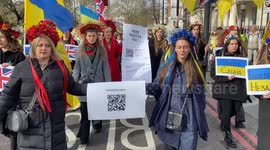 Protesters carry a giant bill for Russia as thousands march in London on the second anniversary of the attack on Ukraine