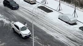 Woman ends up on car's bonnet after driver struggles to brake on icy road