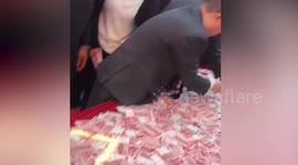 Chinese company lets staff pick banknotes from table in annual bonus game