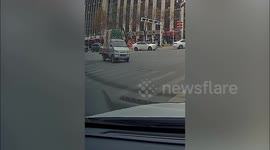 Hundreds of beer crates spill onto street as van overturns on sharp turn
