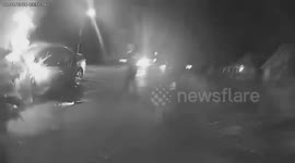 Police officers rescue a woman from a burning vehicle after a crash in Sedalia, MO, USA