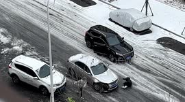 Woman narrowly escapes being run over by car losing control on icy road in eastern China