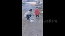 Brother Pulls Sister Away After Lighting Firecrackers in Lianyungang, China