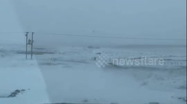 Road conditions. Truck plowing through snow banks on Saskatchewan roads