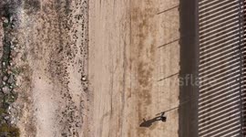 Desperate Journey: Migrant Navigates Jacumba's Border Wall in Search of Entry into the United States