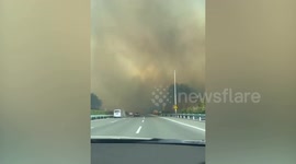 Sky turns fiery orange as massive wildfire engulfs mountain