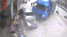 Truck narrowly avoids crowd on roadside in China while dodging motorcyclist