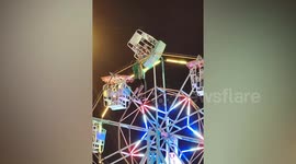 Fairground staff roll gondola upside down when Ferris wheel becomes stuck