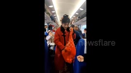 Bride hands out candies to train passengers en route to wedding in China