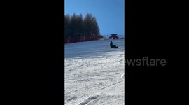 Man on a snowboard doing a trick in Zhangjiakou, China